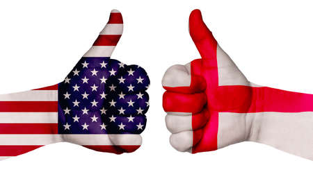 The concept of strengthening the relationship of nations. Two hands are painted with flags of different countries, with a thumb raised up. England and the USAの写真素材
