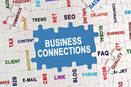 Economy and business concept. Puzzle with economic captions, in the center the inscription - BUSINESS CONNECTIONSの写真素材