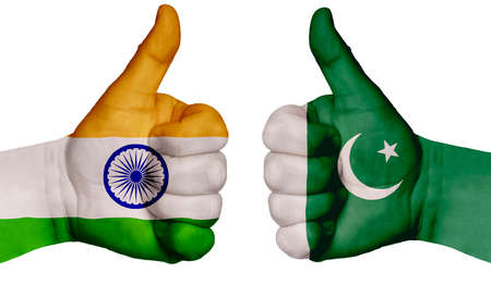 The concept of strengthening the relationship of nations. Two hands are painted with flags of different countries, with a thumb raised up. India and Pakistanの写真素材