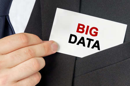 Business concept. Businessman holds a card with the text - BIG DATAの写真素材
