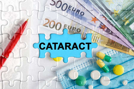 Double exposure. Puzzles with the image of pills, medical mask, pens and euro with the inscription -CATARACT. The concept of medicine.の写真素材