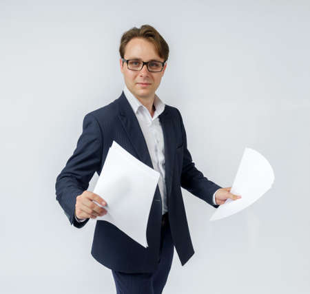Businessman with scattered papers. Business, people, emotions - businessman throws documents in the office. Business and finance concept.の写真素材