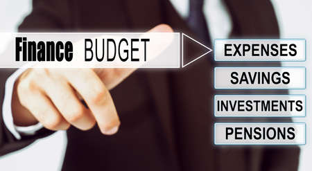 Finance and business concept. Businessman presses button on the interactive screen with the inscription - Finance Budgetの写真素材