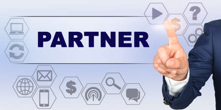 Business concept. Businessman touching virtual screen with his finger. Screen caption - PARTNERの写真素材