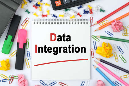 Business concept. On the table is a calculator, diary, markers, pencils and a notebook with the inscription - Data Integrationの写真素材