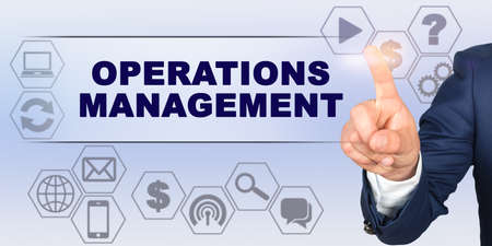 Business concept. Businessman touching virtual screen with his finger. Screen caption - OPERATIONS MANAGEMENTの写真素材
