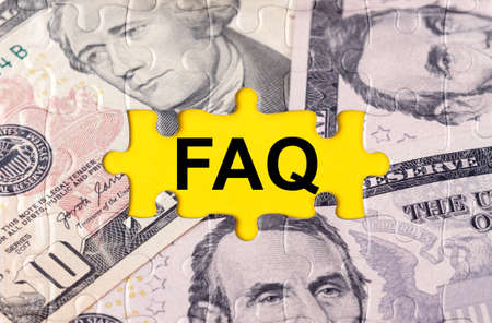 Business concept. Puzzle with the image of dollars in the center of the inscription -FAQの写真素材