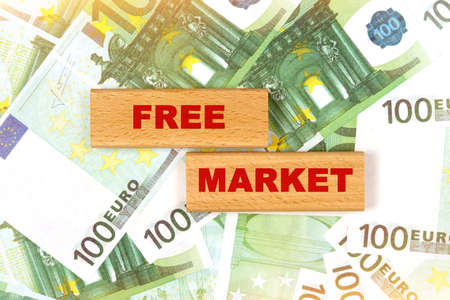 Business concept. Against the background of euro bills, the text is written on wooden blocks - free marketの写真素材