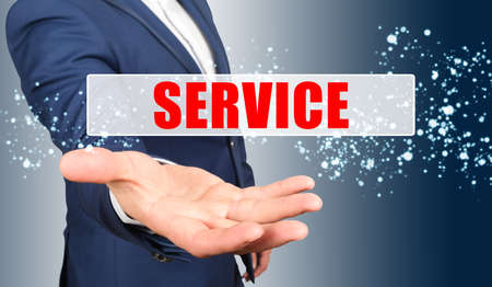 Finance and business concept. A businessman holds his hand, palm up, above the palm the inscription - SERVICEの写真素材