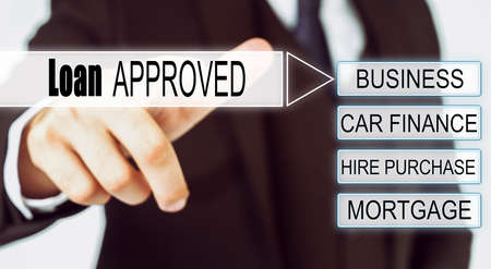 Finance and business concept. Businessman presses button on the interactive screen with the inscription - Loan APPROVEDの写真素材