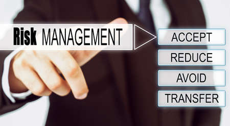 Finance and business concept. Businessman presses button on the interactive screen with the inscription - RISK MANAGEMENTの写真素材