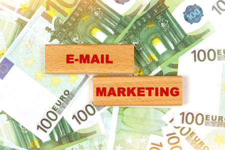 Business concept. Against the background of euro bills, the text is written on wooden blocks - email marketingの写真素材