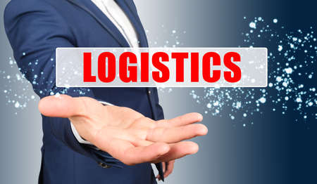 Finance and business concept. A businessman holds his hand, palm up, above the palm the inscription - LOGISTICSの写真素材