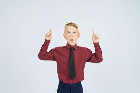 A portrait of a schoolboy showing thumbs up. Education concept.の写真素材