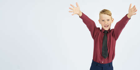 Portrait of a schoolboy with open arms who smiles. Education concept.