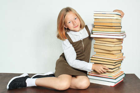 Education concept. A teenage girl sits at the table near the books.の写真素材