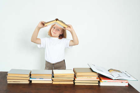 Education concept. The student holds an opened book and holds it down pages.