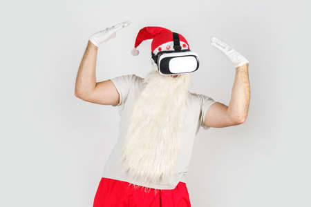 Christmas and New Years concept. Santa Claus in VR glasses plays with different movements. Isolated...