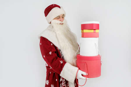 Holidays and Christmas concepts. Santa Claus holds gifts in his hands. Isolated on white