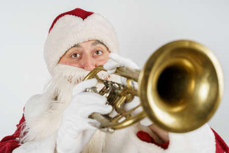 New Year and Christmas concept. Santa Claus plays the pipe. Isolated background