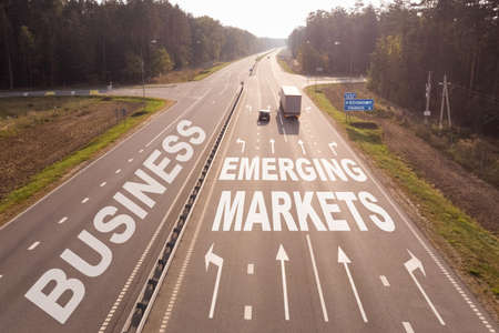 Business and finance concept. Transport is moving along the road, the text of Business and EMERGING MARKETSの写真素材
