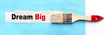 Business and finance concept. On a blue background, the surface is painted white with a brush, on...