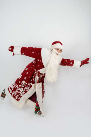 Holidays and christmas concept. Santa Claus is dancing. Isolated on whiteの写真素材