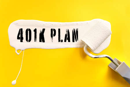 Business and finance concept. On a yellow background, the surface is painted white with a brush, on which it is written - 401K PLANの写真素材
