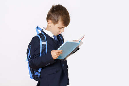 Education concept. A student reads a book. Isolated on white background.の写真素材