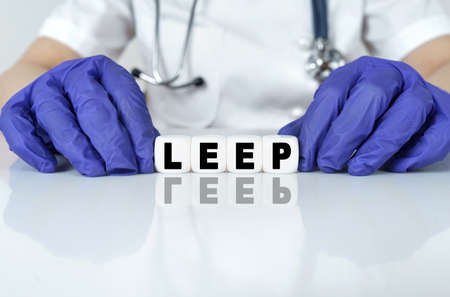 Medicine and health concept. The doctor put together a word from cubes LEEP