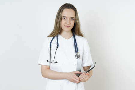 Medicine and health concept. The doctor writes the information into the tablet. Isolated on white background.の写真素材