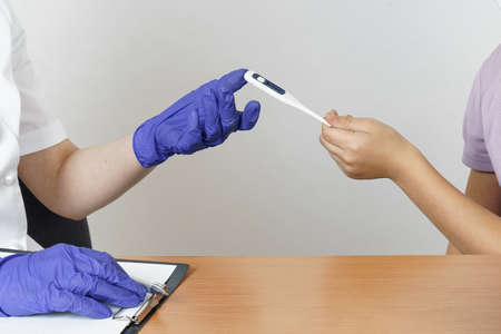 Medicine and health concept. Teenage girl at a pediatrician appointment. The doctor measures the...