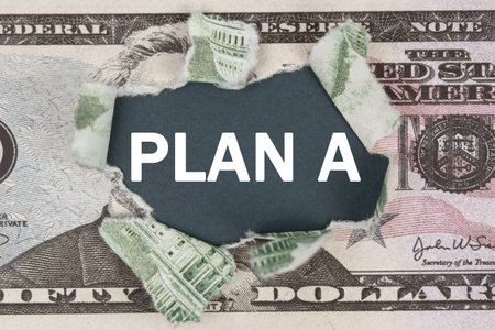 Business and finance concept. The dollar is torn in the center. In the center it is written - PLAN Aの写真素材