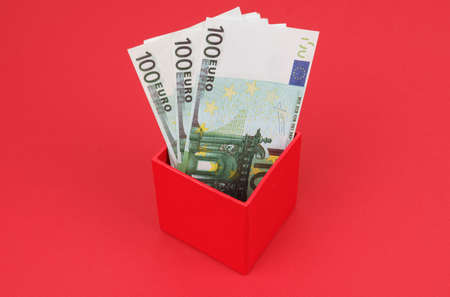 Business and finance concept. On a red background, money is in a red box.