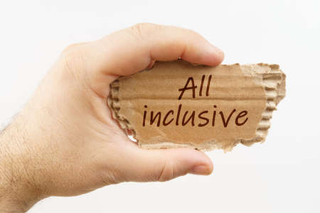 Business and finance. A man holds a cardboard in his hand on which it is written - All inclusiveの写真素材