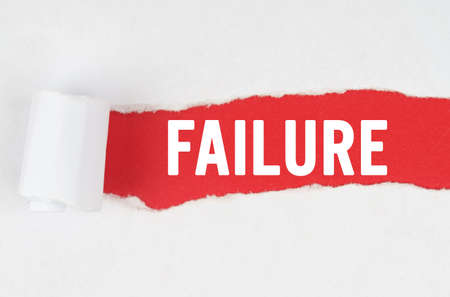 Business and finance. Behind torn white paper on a red background, the text - FAILUREの写真素材
