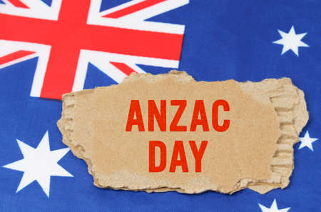 Australian National Holidays. Against the background of the flag of Australia lies cardboard with the inscription -Anzac Dayの写真素材