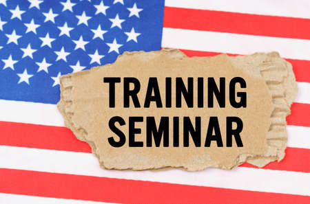 Business and finance concept. On the US flag lies a cardboard box with the inscription- TRAINING...