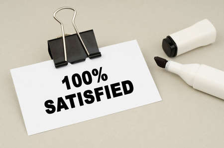 Finance and business concept. On a gray background lies a marker and a business card with the...