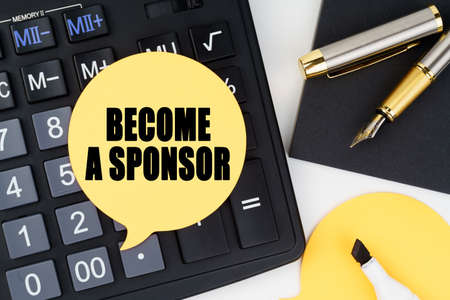 Business and economy concept. There is a calculator, a pen, a marker and a sticker with the inscription - BECOME A SPONSORの写真素材