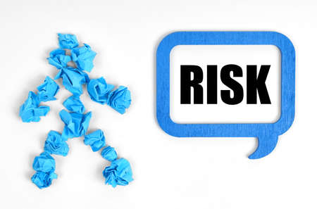 Medicine and health concept. On a white background, a blue man and a sign with the inscription - RISKの写真素材