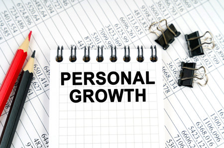 Business concept. On the table are reports, pencils and a notebook with the inscription - Personal growthの写真素材