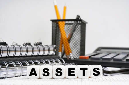 Business and finance concept. On the table, among office objects, cubes with the inscription -の写真素材