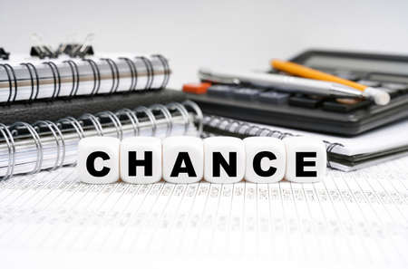 Business and finance concept. On the table, among office objects, cubes with the inscription -の写真素材