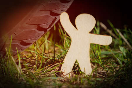 Ecology concept. The wooden man tries to stop the car.の写真素材