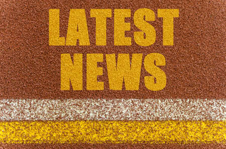 Business and finance concept. On the treadmill, lines and an inscription - LATEST NEWS