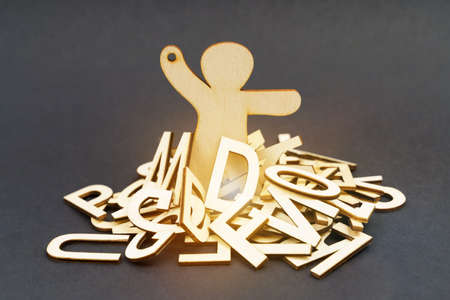 Problems, business and health. The figurine of the wooden man is littered with problems - letters. Asks for help.の写真素材