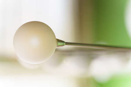 Lighting devices. White round lamp shades on the ceiling of the room.の写真素材