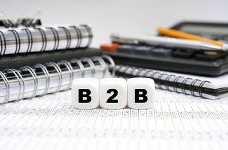 Business and finance concept. On the table, among office objects, cubes with the inscription - B2Bの写真素材