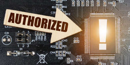 Internet and security concept. On the computer board, a microcircuit with an exclamation mark and an...